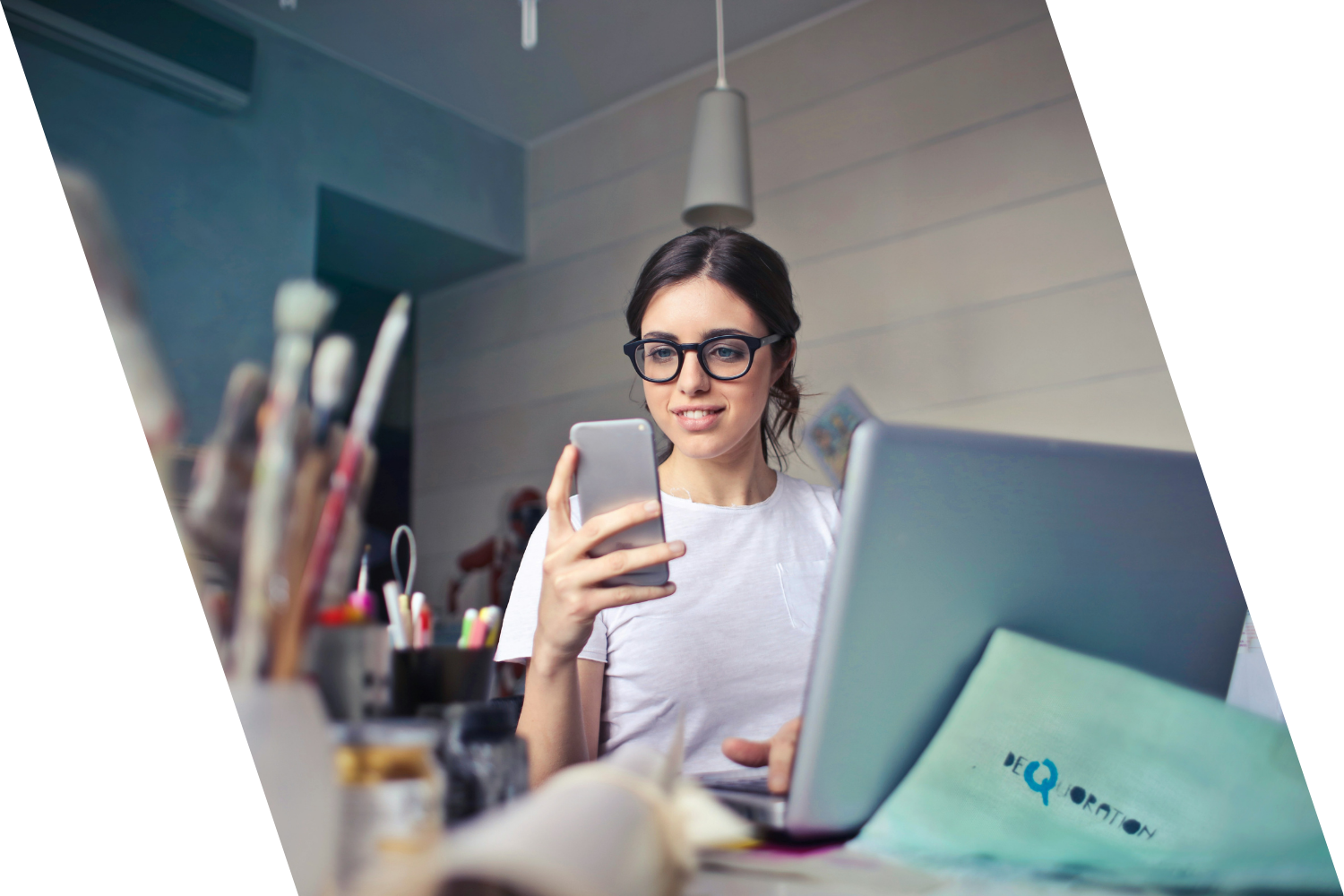 woman checking phone at workspace